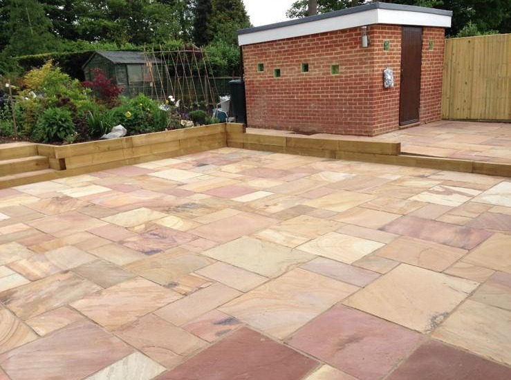 Large sandstone patio with sleeper retaining walls built by SMB Groundworks and Servicing in Kent