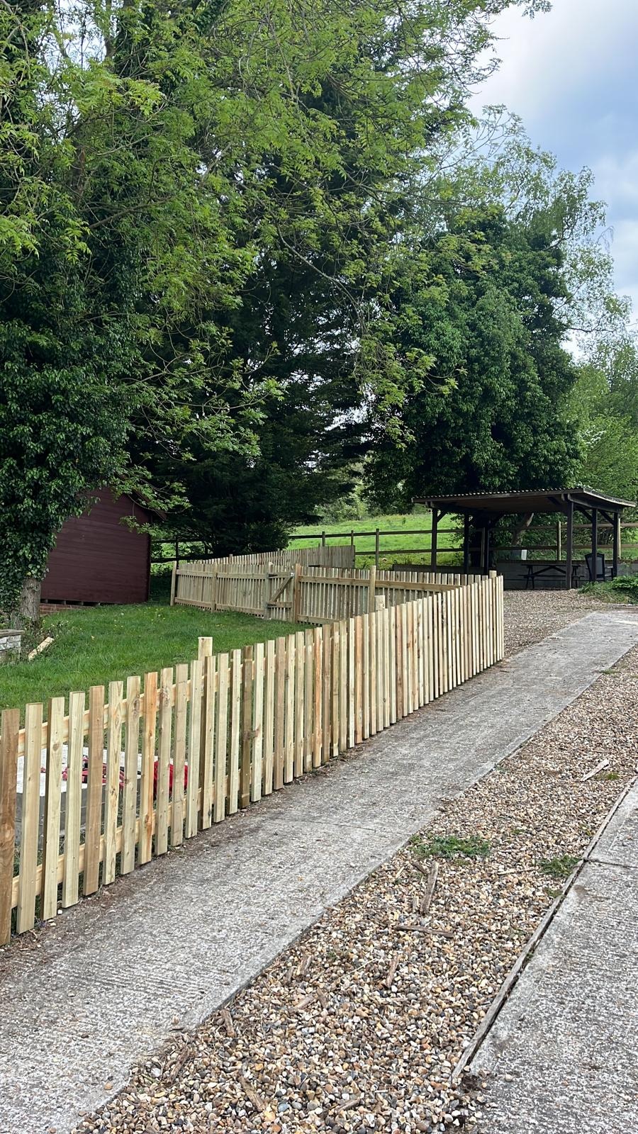 Picket fencing running alongside a driveway in Kent