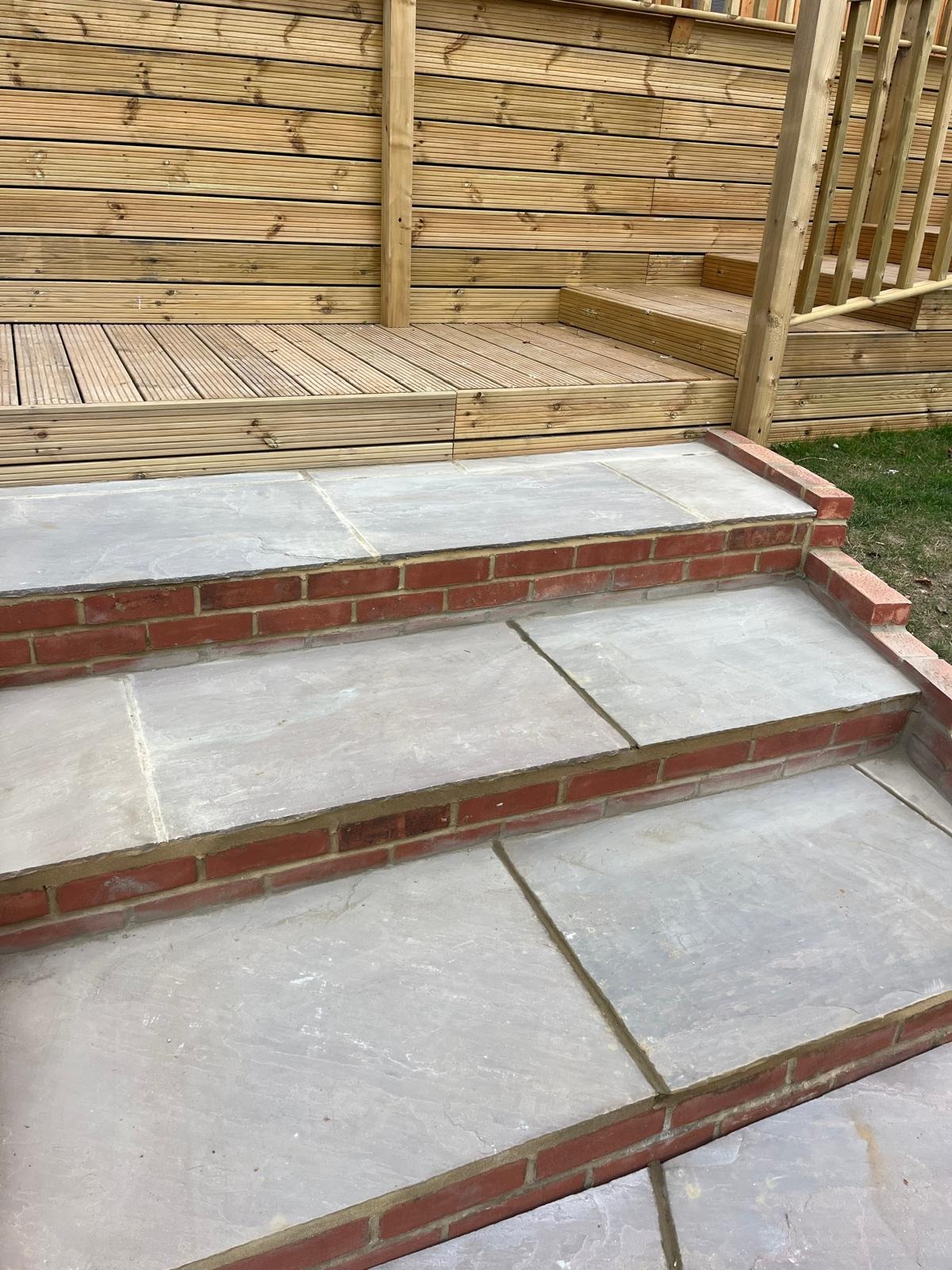Indian sandstone patio with brick-edged steps in Kent